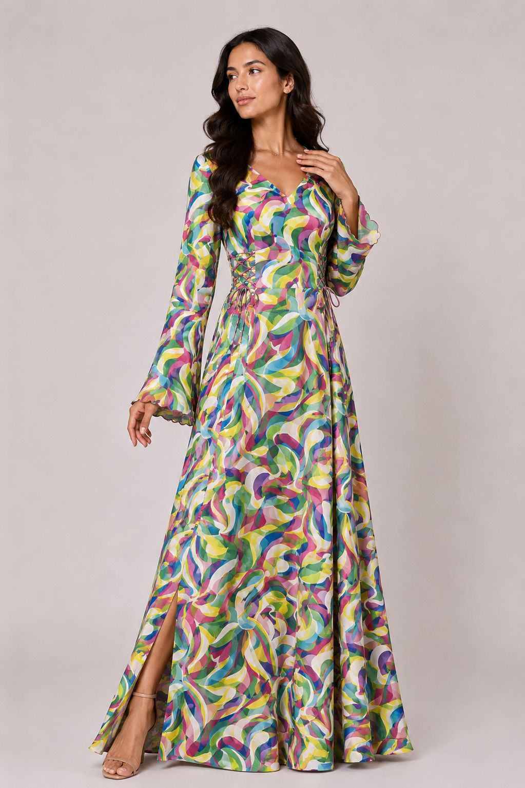 Woman wearing a colorful patterned dress on a plain background