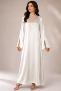 NC#CT3 — White full-length dress with draped decorative neckline.