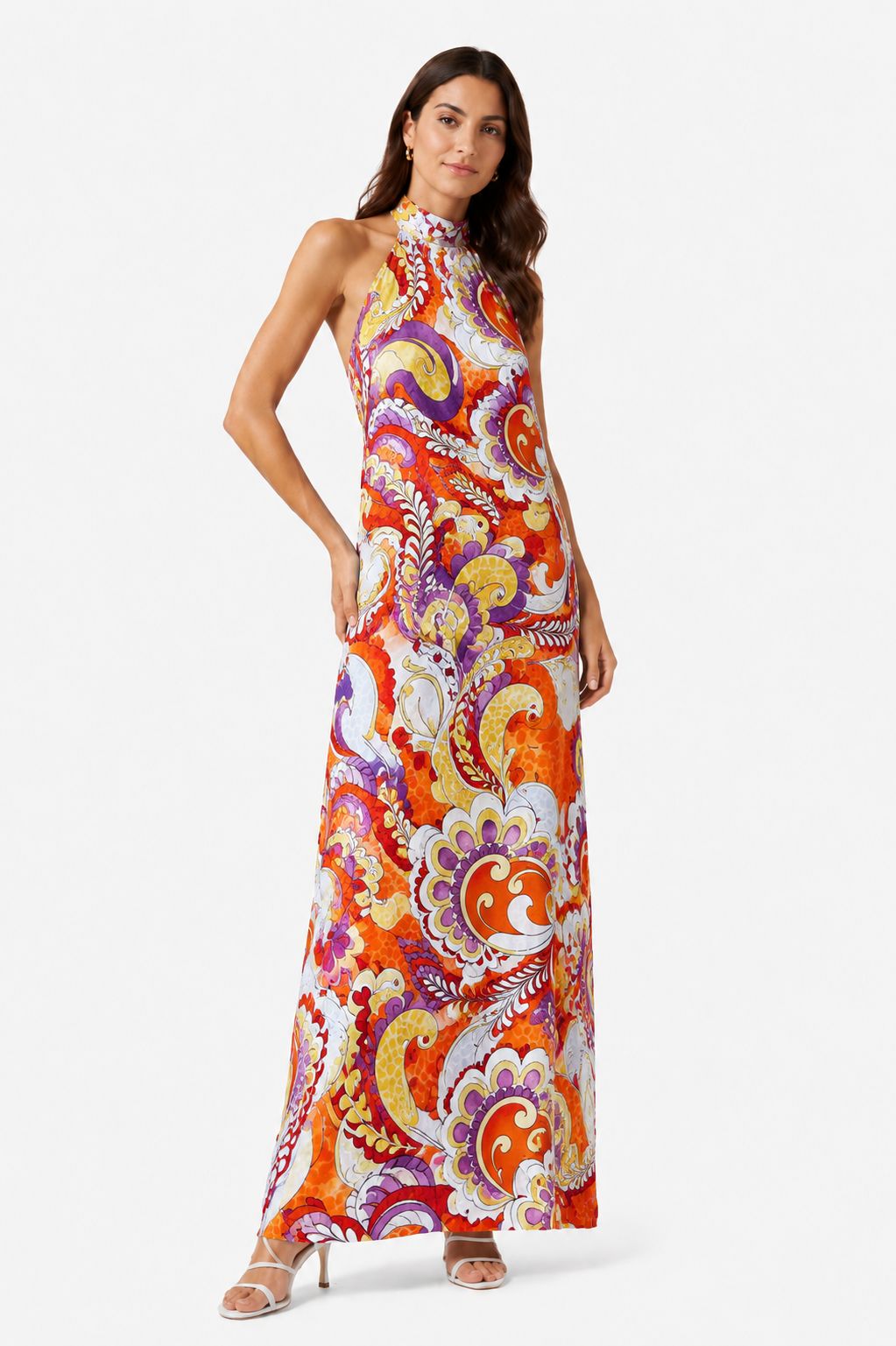 Woman wearing a colorful patterned dress on a white background